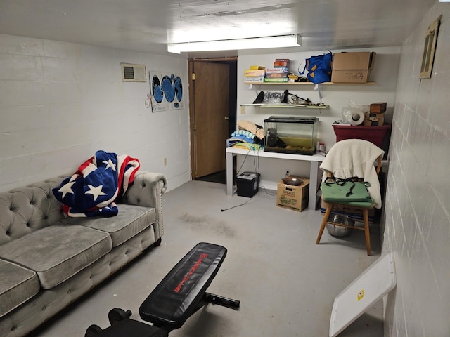 interior space featuring visible vents and concrete block wall