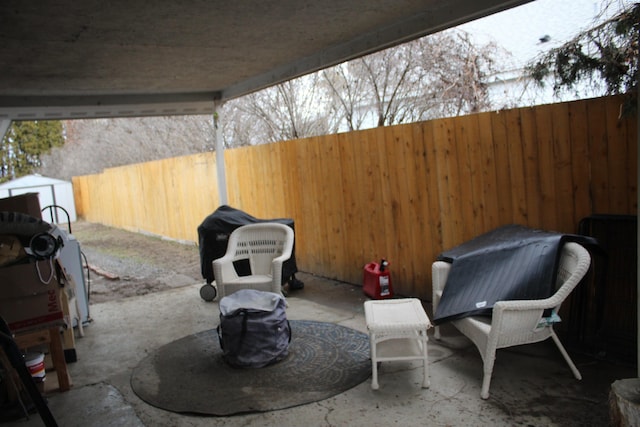 view of patio / terrace featuring a storage shed and a fenced backyard