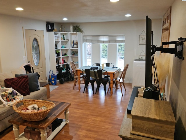 dining room with light wood-style flooring and recessed lighting