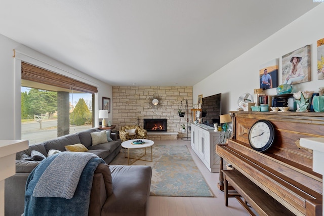 living room with a fireplace and light wood-type flooring