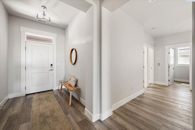 entryway featuring wood finished floors and baseboards