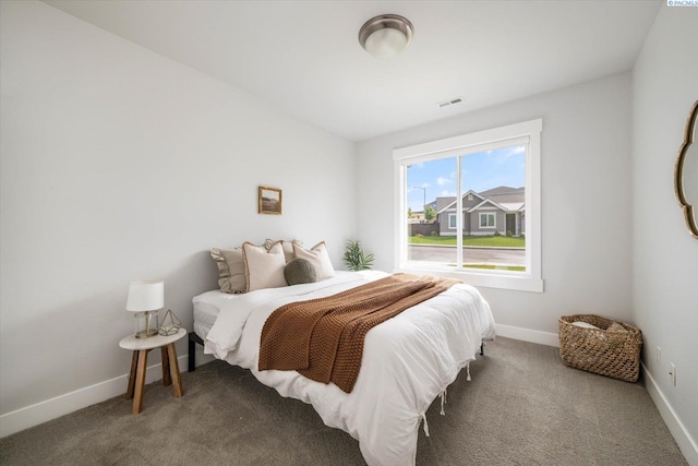 bedroom featuring carpet flooring and baseboards