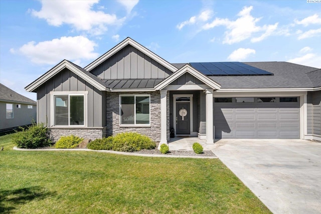 2237 Legacy Ln, Richland, WA 99352 - view of front facade with board and batten siding, solar panels, a garage, a front yard, and driveway