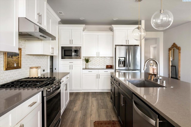 2237 Legacy Ln, Richland, WA 99352 - kitchen featuring stainless steel appliances, under cabinet range hood, white cabinetry, decorative backsplash, and recessed lighting