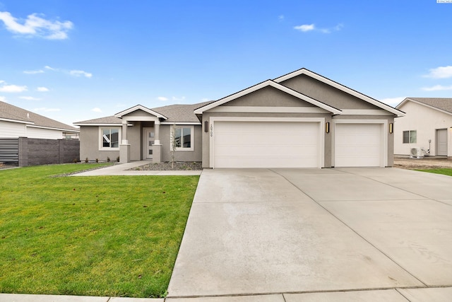 ranch-style house with stucco siding, driveway, fence, an attached garage, and a front yard