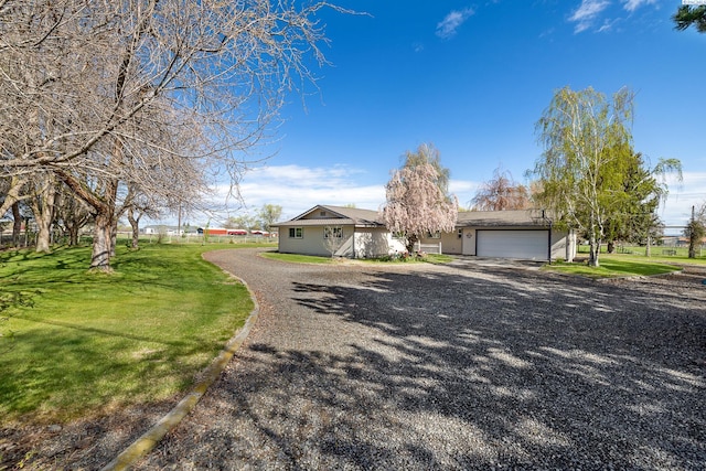108 W 45th Ave, Kennewick, WA 99337 - view of front of home featuring an attached garage, driveway, and a front yard