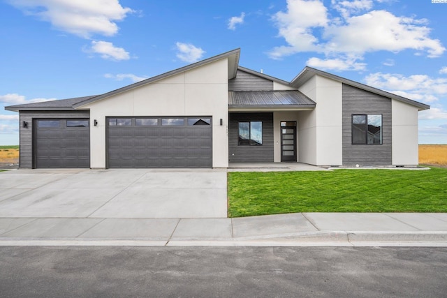 view of front of home with a front lawn and a garage