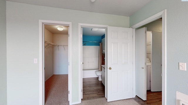 1645 NE Merman Dr Unit D 301, Pullman, WA 99163 - unfurnished bedroom with a closet, a spacious closet, ensuite bathroom, and wood finished floors