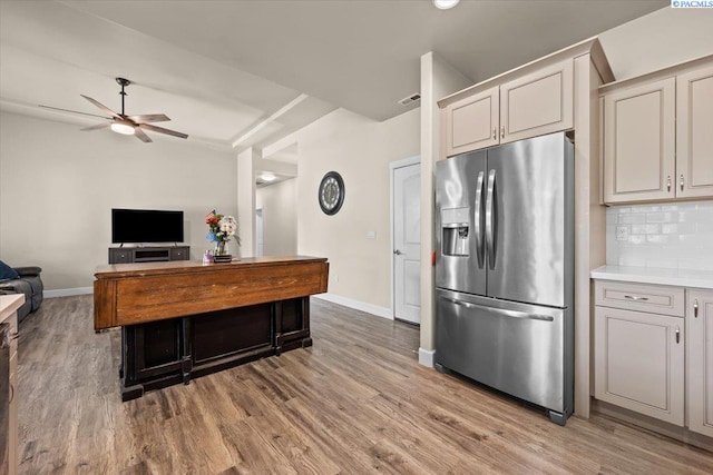 406 W 49th Ave, Kennewick, WA 99337 - kitchen with stainless steel refrigerator with ice dispenser, a ceiling fan, baseboards, light wood-style floors, and decorative backsplash