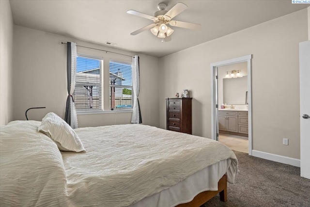 406 W 49th Ave, Kennewick, WA 99337 - bedroom featuring light carpet, a sink, connected bathroom, baseboards, and ceiling fan