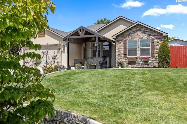 406 W 49th Ave, Kennewick, WA 99337 - view of front of house featuring stone siding, stucco siding, and an attached garage