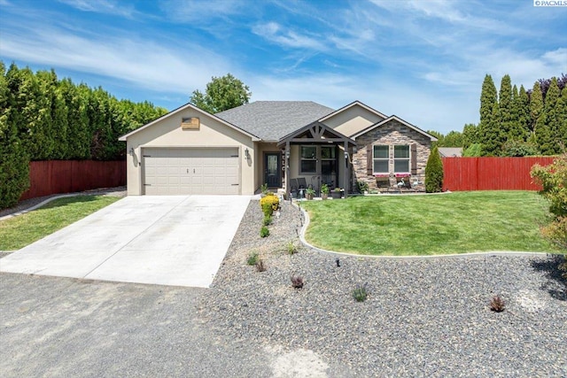 406 W 49th Ave, Kennewick, WA 99337 - view of front of property featuring a garage, concrete driveway, stone siding, and stucco siding