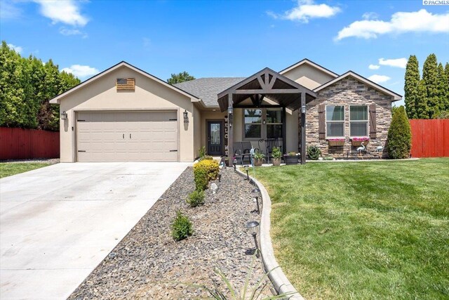 406 W 49th Ave, Kennewick, WA 99337 - view of front of property with stucco siding, a garage, driveway, and stone siding
