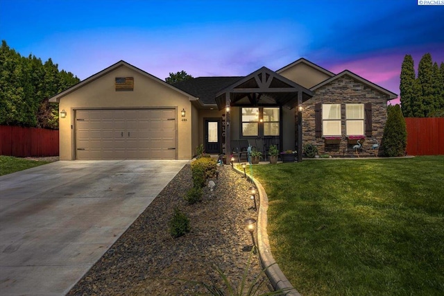 406 W 49th Ave, Kennewick, WA 99337 - ranch-style house with driveway, stucco siding, a garage, and stone siding