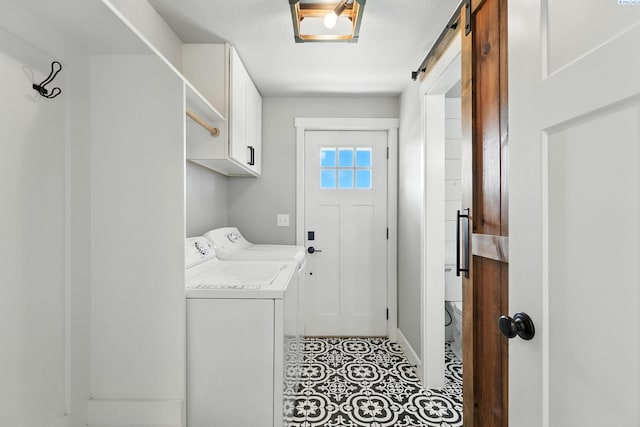 10401 N Mcdonald Rd, Prosser, WA 99350 - laundry area with cabinet space, separate washer and dryer, a barn door, and light tile patterned flooring