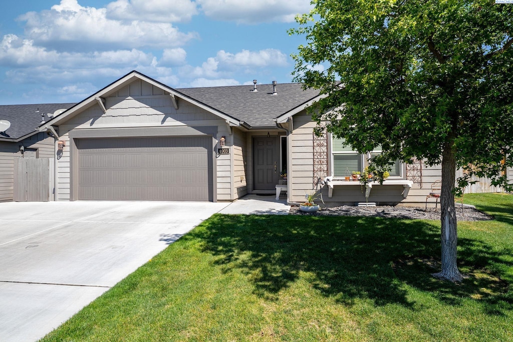 6903 Boulder Dr, Pasco, WA 99301 - view of front facade featuring a garage, driveway, and roof with shingles