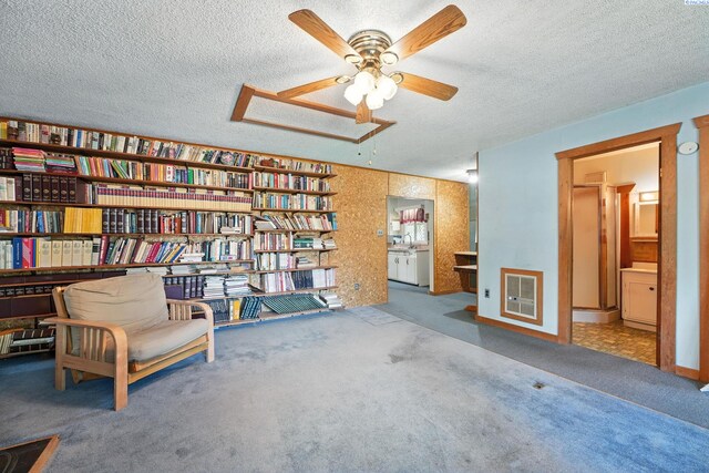 219 E 6th Ave, Kennewick, WA 99336 - living area with carpet flooring, a textured ceiling, ceiling fan, and heating unit