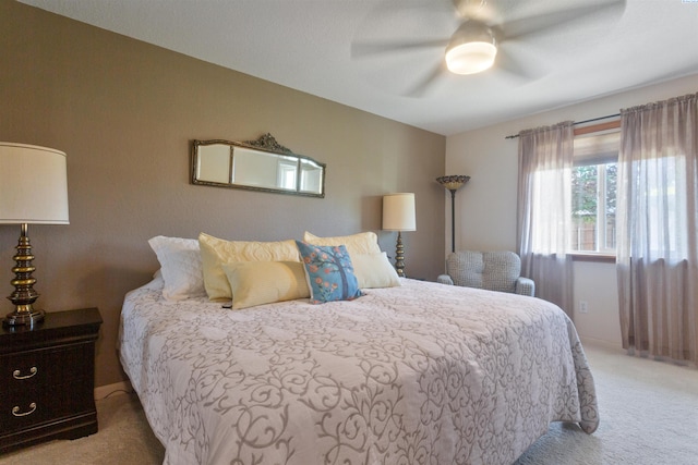 bedroom featuring ceiling fan and light carpet