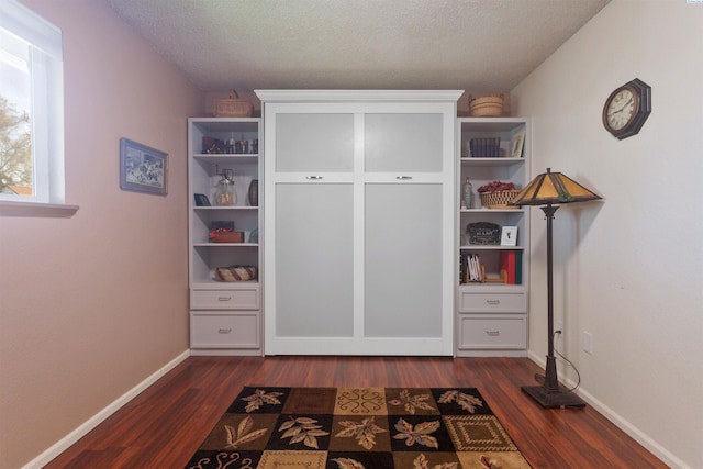 mudroom with baseboards, a textured ceiling, and dark wood finished floors