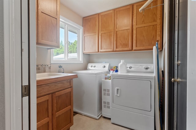 laundry room with cabinet space and washer and clothes dryer