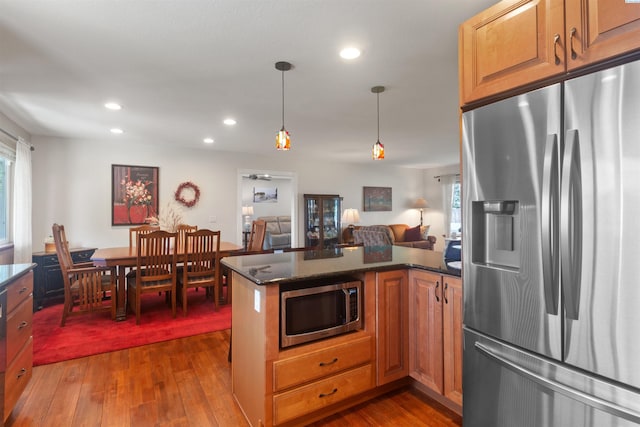 kitchen with stainless steel appliances, recessed lighting, open floor plan, and dark wood-type flooring