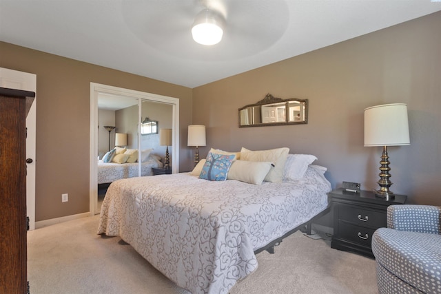 bedroom with a ceiling fan and light carpet