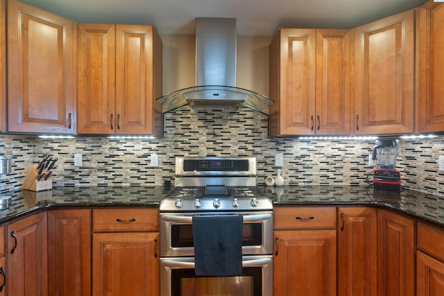 kitchen featuring brown cabinetry, backsplash, double oven range, and wall chimney exhaust hood