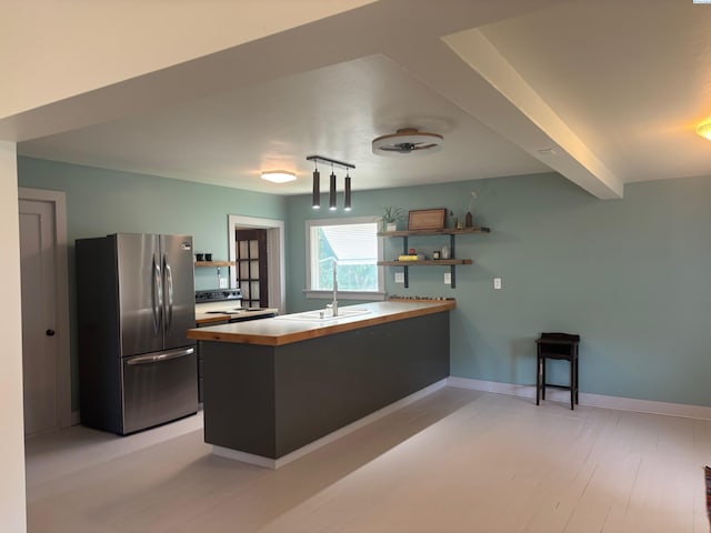 310 S Culton St, Palouse, WA 99161 - kitchen with freestanding refrigerator, open shelves, a peninsula, and electric range oven