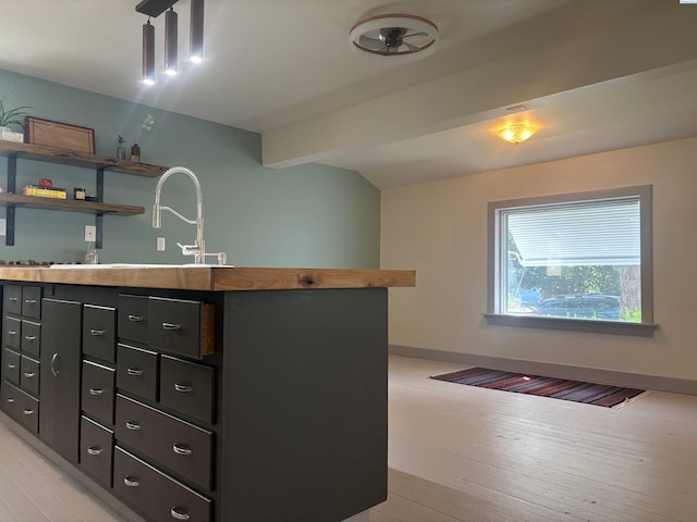 310 S Culton St, Palouse, WA 99161 - kitchen with light wood-type flooring, vaulted ceiling, open shelves, and dark cabinets