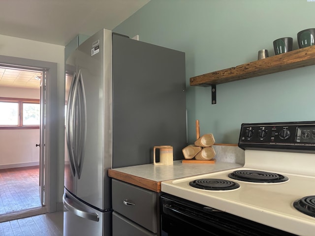 310 S Culton St, Palouse, WA 99161 - kitchen with white electric range, freestanding refrigerator, and light countertops