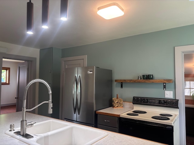 310 S Culton St, Palouse, WA 99161 - kitchen with electric stove, freestanding refrigerator, and light countertops