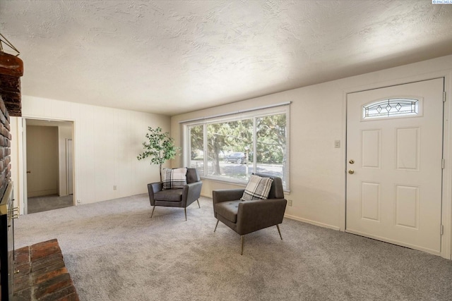 foyer entrance with carpet floors, healthy amount of natural light, and a textured ceiling
