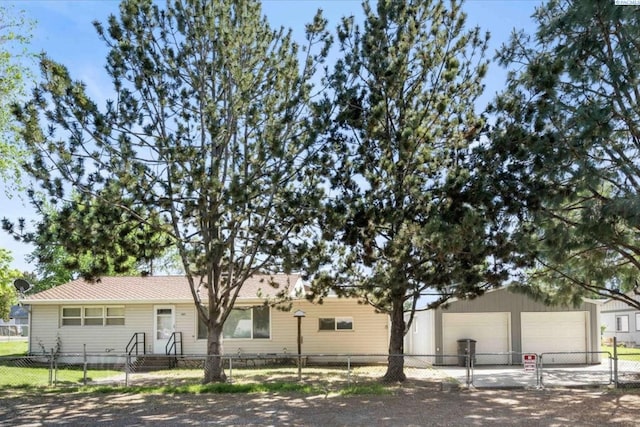 view of front of property featuring a fenced front yard and a garage