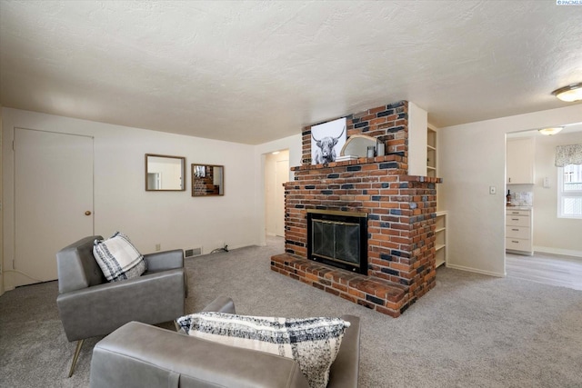carpeted living room with a brick fireplace, baseboards, and a textured ceiling