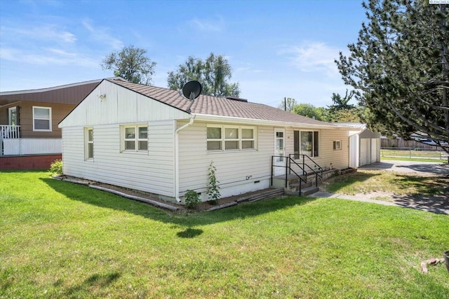 rear view of property featuring a yard