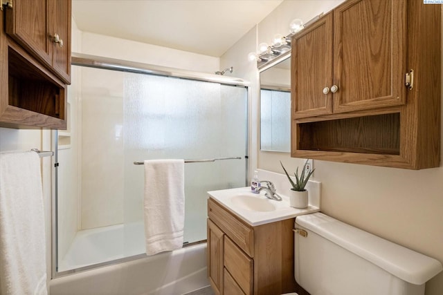 full bathroom with enclosed tub / shower combo, toilet, and vanity