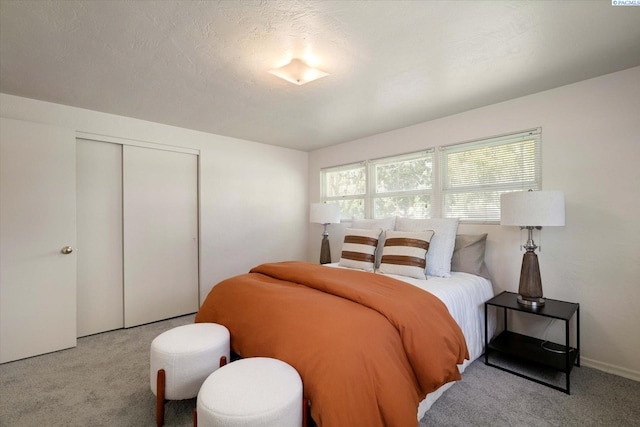 bedroom with carpet and a closet