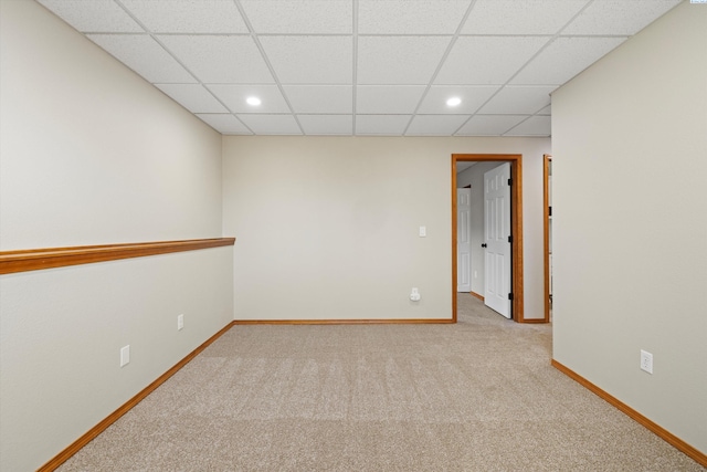 carpeted spare room with baseboards, a drop ceiling, and recessed lighting