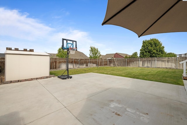 view of patio / terrace with a fenced backyard, an outdoor structure, and a shed