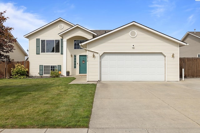 view of front of home featuring an attached garage, driveway, fence, and a front yard