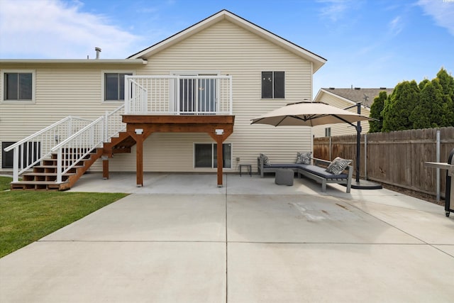 back of house featuring a patio area, stairway, fence, and a lawn