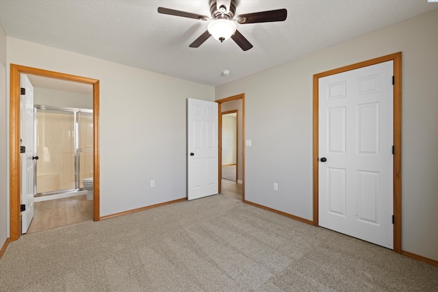 unfurnished bedroom with carpet flooring, connected bathroom, baseboards, and ceiling fan