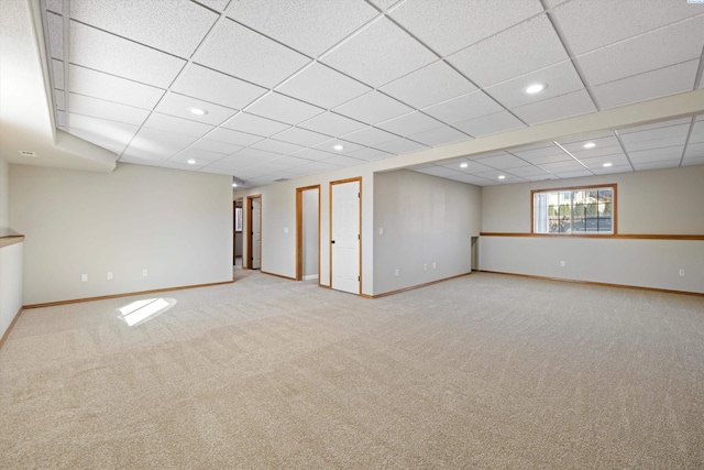 below grade area with a paneled ceiling, carpet, baseboards, and recessed lighting