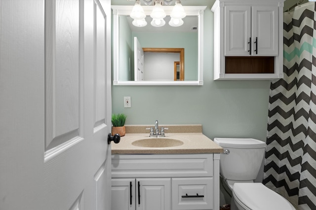 full bathroom with toilet and vanity