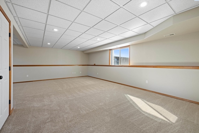 below grade area featuring carpet floors, a drop ceiling, recessed lighting, and baseboards