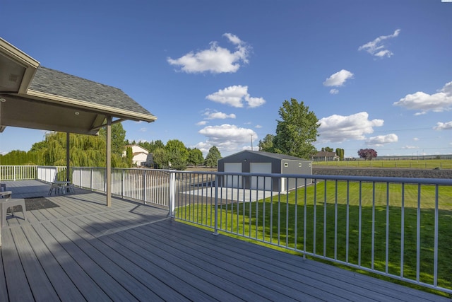92104 E Sagebrush Rd, Kennewick, WA 99338 - wooden deck featuring a detached garage, an outdoor structure, and a lawn
