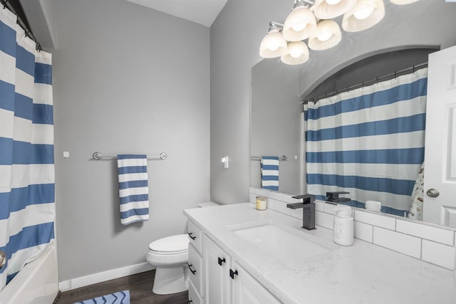 92104 E Sagebrush Rd, Kennewick, WA 99338 - full bathroom featuring wood finished floors, vanity, toilet, baseboards, and a chandelier