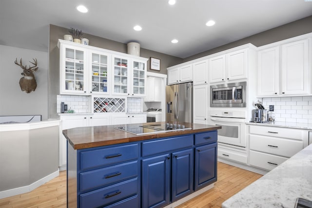 92104 E Sagebrush Rd, Kennewick, WA 99338 - kitchen featuring stainless steel appliances, blue cabinets, white cabinets, light wood-style flooring, and recessed lighting