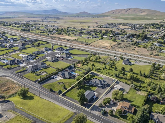92104 E Sagebrush Rd, Kennewick, WA 99338 - aerial view of property and surrounding area featuring a mountainous background and nearby suburban area
