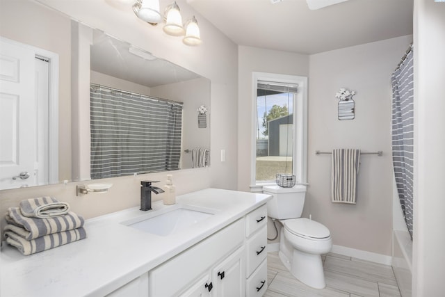 92104 E Sagebrush Rd, Kennewick, WA 99338 - full bathroom with vanity, toilet, and baseboards